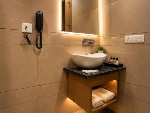 a bathroom with a sink and a phone on the wall at Hotel Nayyar Regency Near Golden temple in Amritsar +27 photos