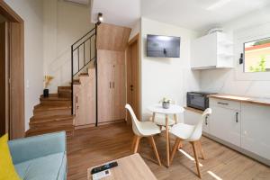 a kitchen and living room with a table and chairs at Oropion Rental houses in Néa Palátia