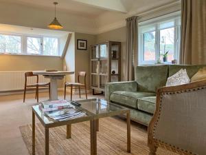 a living room with a couch and a table at Pine View - Uk50699 in St Margarets at Cliff