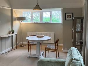 a living room with a table and a couch at Pine View - Uk50699 in St Margarets at Cliff