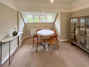 a small dining room with a table and chairs at Pine View - Uk50699 in St Margarets at Cliff