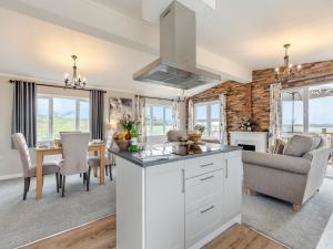 a kitchen and living room with a couch and a table at Church View - Uk46896 in Kinlet