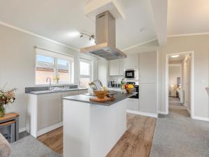 a kitchen with white cabinets and a counter top at Church View - Uk46896 in Kinlet
