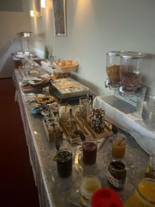 a buffet line with a long table filled with food at Haus ÜberLand in Sundhagen-Niederhof