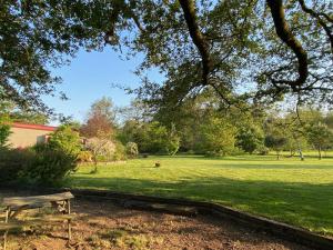 a park with a bench in the grass at Le Domaine d'Elissois in Saint-Nicolas-de-Redon