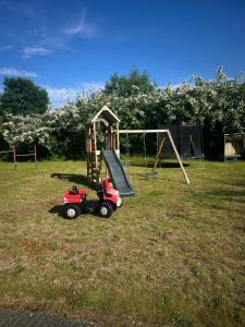 a playground with a toy truck and a slide at Haus ÜberLand in Sundhagen-Niederhof