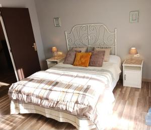 a bedroom with a large bed with two night stands at EL LLIMONER in Sant Jordi