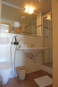 a bathroom with a sink and a toilet at Hotel - Restaurant Gosauerhof in Gosau