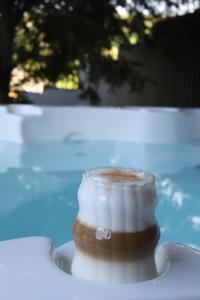 a cup of coffee sitting on a plate on a table at Bakony Kincse Vendégház in Jásd