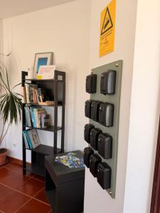a room with a bunch of suitcases on a wall at Retiro dos Batudes in Palmela