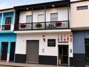a building with a balcony with flowers on it at Hotel Altara AQP in Arequipa