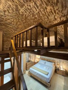 a bedroom with a bunk bed and a staircase at Casa Di Lithos in Mestá