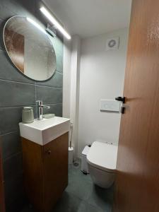 a bathroom with a toilet and a sink and a mirror at Casa Di Lithos in Mestá
