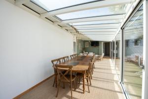 a dining room with a long table and chairs at Villa Sarment Oleron in Saint-Pierre-dʼOléron