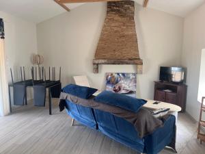 a living room with a blue couch and a table at Le panorama de Canteloup in Fours
