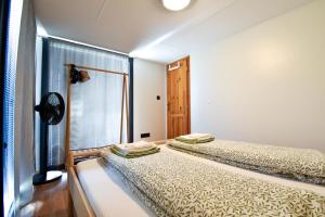 two beds in a room with a window at Arktik in Bojnice +10 photos