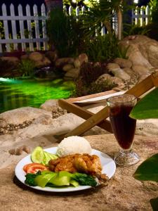 a plate of food on a table with a drink at Sol Flow Retreat in Nguyên Ngoại