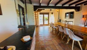 a dining room with a long table and chairs at Secrets Rural House in Jávea