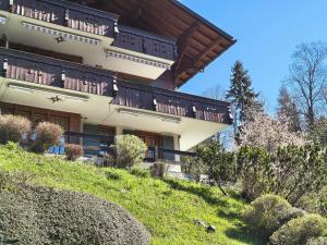 a building on a hill with plants in front of it at El Balcón des Diablerets in Les Diablerets