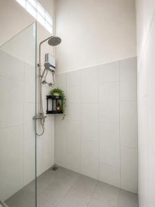 a bathroom with a shower with a glass door at Primera Vacation Home in Luang Prabang +13 photos