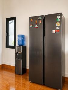 a refrigerator with magnets on the side of a wall at Primera Vacation Home in Luang Prabang