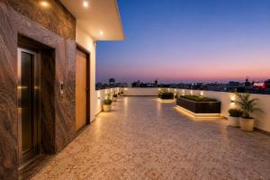 a large room with a balcony with a view of the city at Hotel Nayyar Regency Near Golden temple in Amritsar
