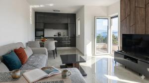 a living room with a couch and a tv at Apartman SOFI in Ulcinj