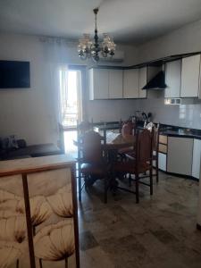 a kitchen and dining room with a table and chairs at appartamento 4 piano in Chioggia