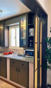 a kitchen with a counter with two surfboards on the wall at سديم الفجر للنزل السياحية بيوت عطلات وشاليهات - فئه اقتصادى in Taif
