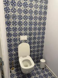 a bathroom with a toilet with blue and white tiles at Aqua Azzuro Lovran in Lovran +31 photos