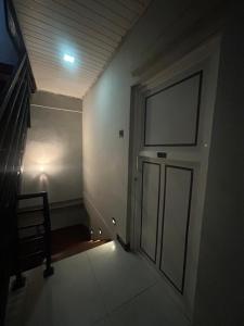 an empty hallway with a door and a staircase at Urban Vibe Kandy in Kandy