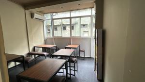 a room with tables and chairs and a window at Urban Vibe Kandy in Kandy