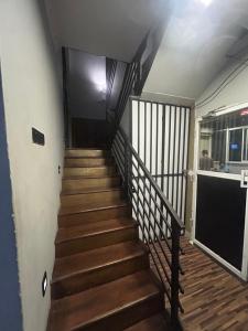 a staircase in a house with wooden floors at Urban Vibe Kandy in Kandy