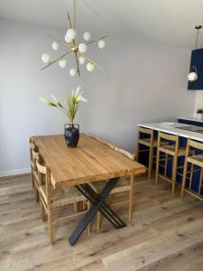 a dining room table with a potted plant on it at Aqua Azzuro Lovran in Lovran