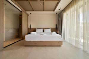 a bedroom with a white bed and a large window at La Finestra in Nydri +147 photos