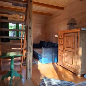 a living room with a couch in a log cabin at Vikendica Breza 2 in Zaovine