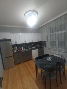 a kitchen with a dining room table and a table and chairs at Qebele gunluk ev in Bum