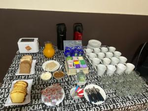 a table with food and drinks and cups on it at Casa LYON in Barraquero