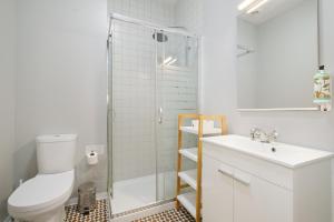 a bathroom with a shower and a toilet and a sink at Mouzinho 244 - Porto Houses & Suites in Porto +47 photos