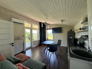 a kitchen and living room with a couch and a table at Borzhava View Chalet in Nizhniy Studenyy +48 photos