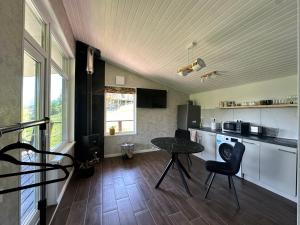 a kitchen with a table and chairs in a room at Borzhava View Chalet in Nizhniy Studenyy