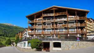 a large building on top of a mountain at Hostdomus - Royal Oak in Sestriere