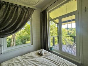 a bedroom with a bed and a large window at Borzhava View Chalet in Nizhniy Studenyy