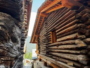 a log building with a window on the side of it at Alpine Majestic Rascard - Unique Mountain Experience with Balcony and panoramic views in Champoluc +32 photos
