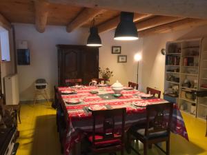 a dining room with a table with a red table cloth at Ferme de Chaudeyrac in Saint-Front