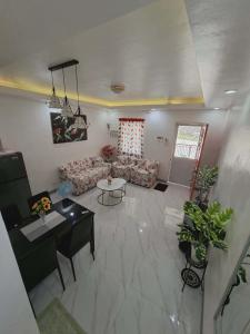 a living room with a couch and a table at Compostela Two Story Richwood Townhome Breakfast Offered in Compostela