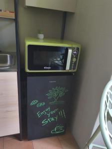 a microwave oven sitting on top of a refrigerator at Porta Del Ricetto in Candelo