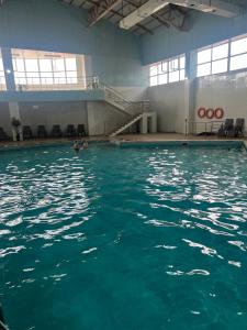 a pool of water with two people swimming in it at АпартаментРадугаВест1 in Koshkolʼ