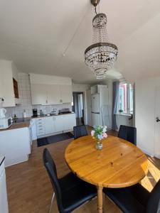 a kitchen and dining room with a wooden table and chairs at Grevgatan 4 Apt 1101 in Eksjö