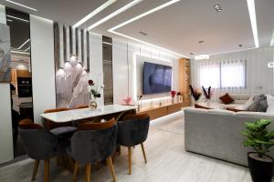 a living room with a couch and a table and chairs at flora bay luxe in Agadir